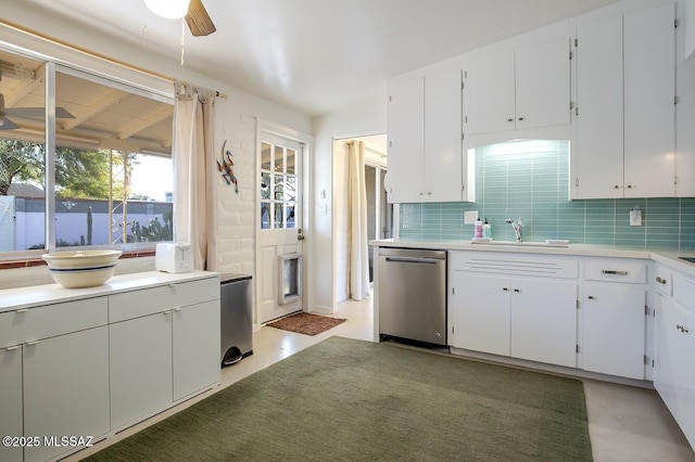 kitchen with a sink, white cabinets, light countertops, and dishwasher