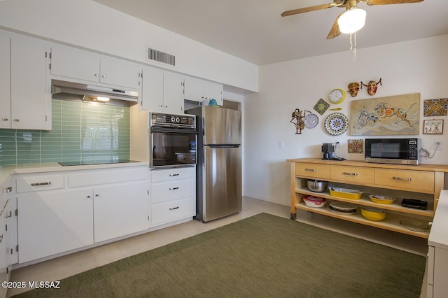 kitchen featuring visible vents, under cabinet range hood, light countertops, black appliances, and white cabinetry