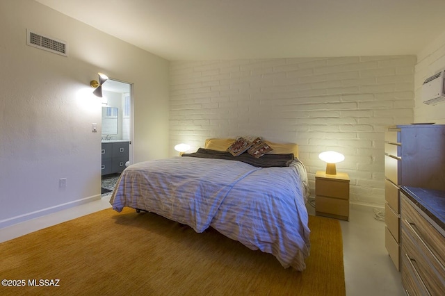 bedroom with brick wall, visible vents, and baseboards