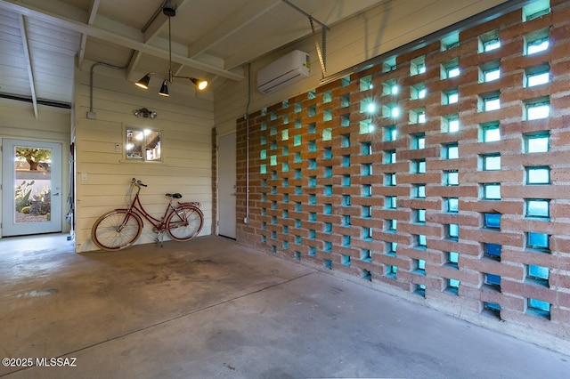 garage with a wall unit AC and wood walls