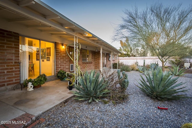 view of yard featuring fence and a patio