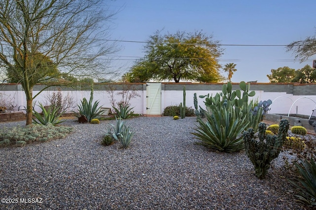 view of yard featuring fence and a gate