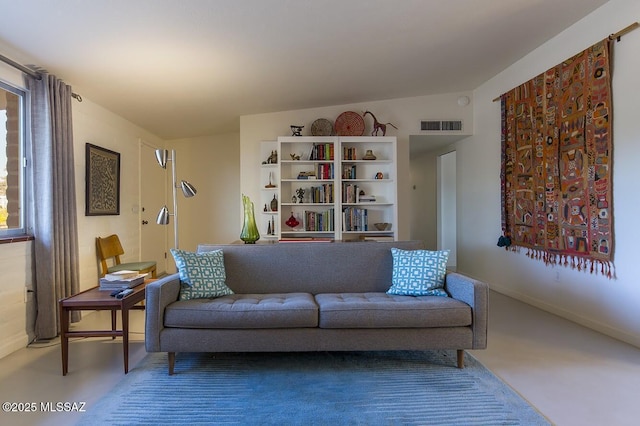 living area featuring visible vents and baseboards