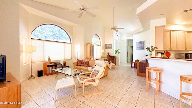 interior space with light tile patterned floors, ceiling fan, and visible vents