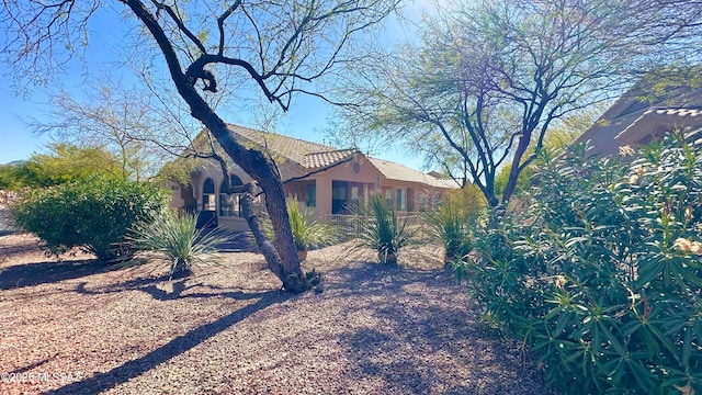 view of side of home with stucco siding