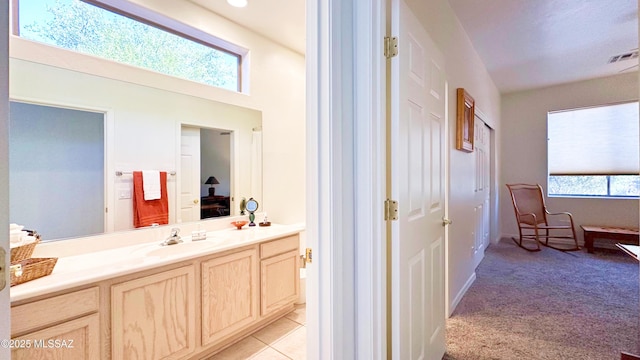 ensuite bathroom with a wealth of natural light, visible vents, vanity, and ensuite bathroom