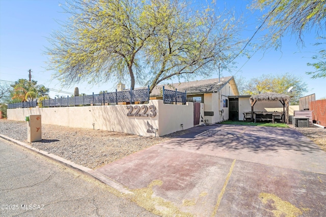 exterior space with a fenced front yard and stucco siding