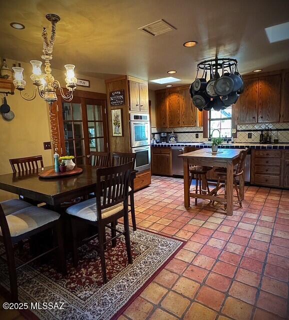 dining space featuring recessed lighting, visible vents, a notable chandelier, and light tile patterned floors