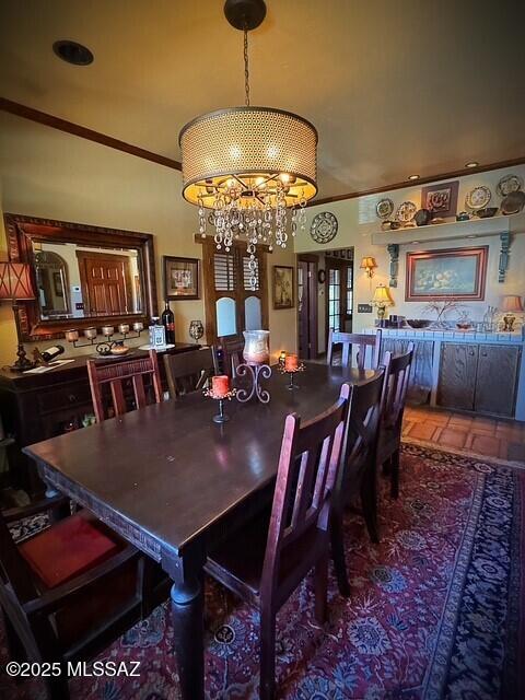 dining area with an inviting chandelier and crown molding