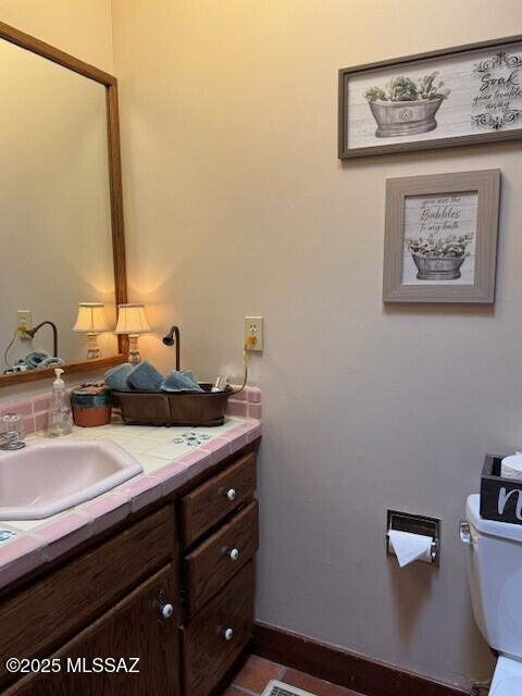 half bathroom with toilet and vanity