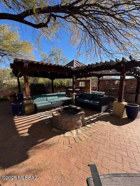 view of patio / terrace featuring an outdoor living space with a fire pit and a pergola