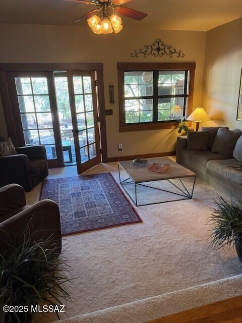 carpeted living room with ceiling fan and a wealth of natural light