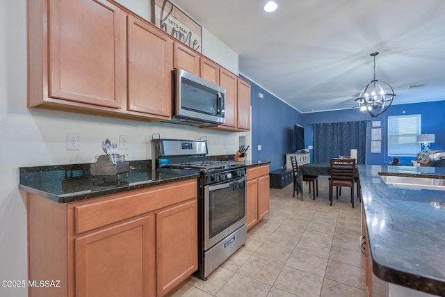 kitchen featuring a sink, a chandelier, hanging light fixtures, light tile patterned floors, and stainless steel appliances