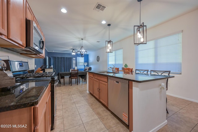 kitchen featuring a sink, visible vents, light tile patterned floors, and appliances with stainless steel finishes