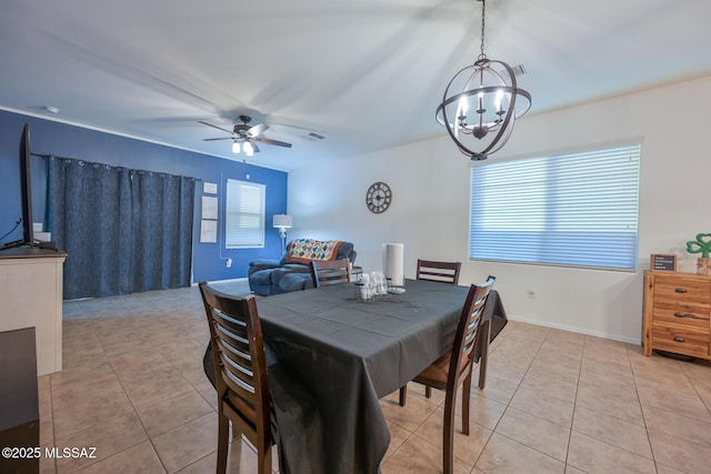 dining area featuring ceiling fan with notable chandelier, visible vents, baseboards, and light tile patterned floors