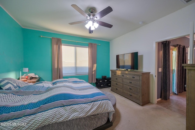 bedroom with light carpet, ceiling fan, and ornamental molding