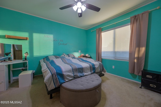 carpeted bedroom featuring baseboards, ornamental molding, and ceiling fan
