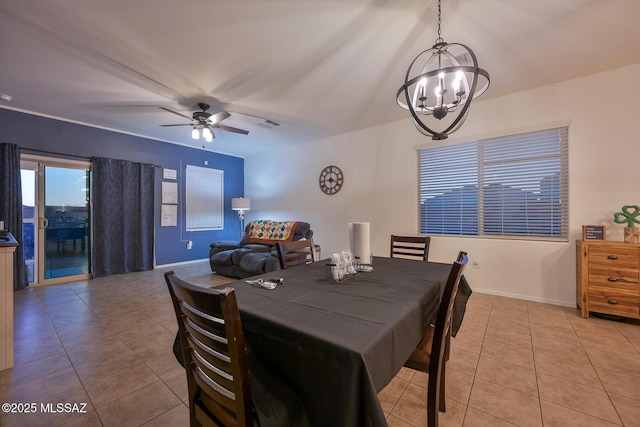 dining space featuring light tile patterned floors, ceiling fan with notable chandelier, and baseboards