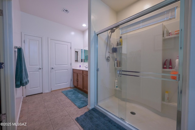 bathroom featuring visible vents, tile patterned floors, vanity, and a stall shower