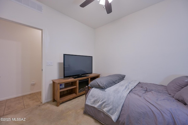 bedroom with tile patterned flooring, carpet, baseboards, ceiling fan, and visible vents