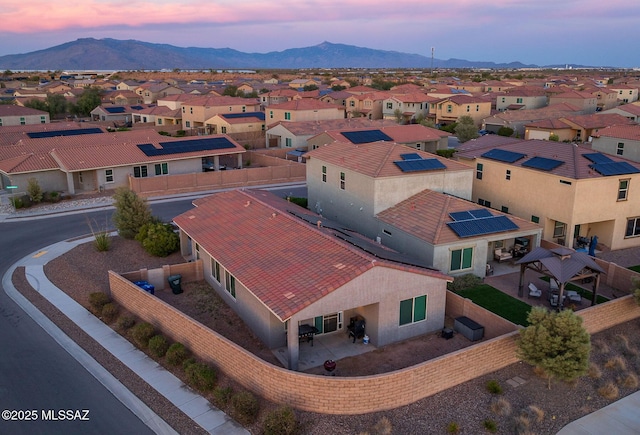 aerial view at dusk with a mountain view and a residential view