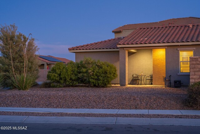 view of front of home featuring a tile roof and stucco siding