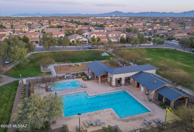 pool with a residential view, a mountain view, fence, and a patio