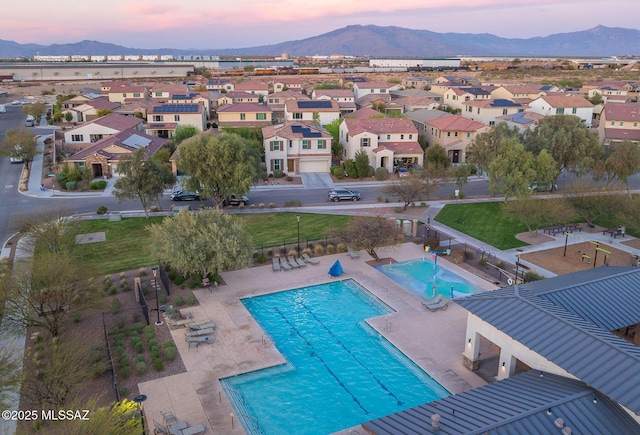 pool featuring fence, a residential view, a patio area, and a mountain view