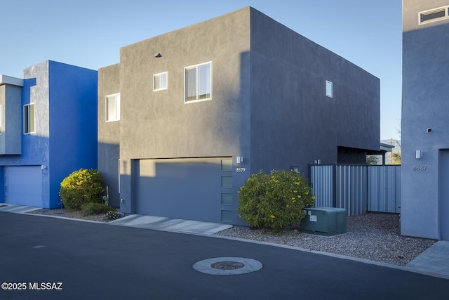 view of front of house with an attached garage and stucco siding