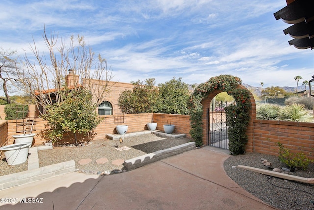 view of patio / terrace featuring a gate and fence