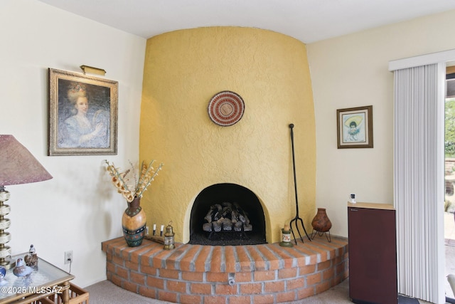 living room featuring a brick fireplace and carpet