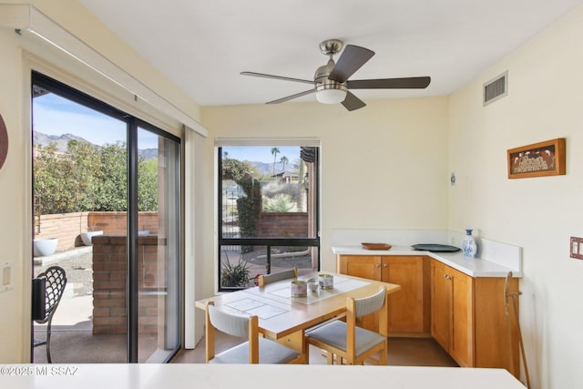 interior space with a ceiling fan and visible vents