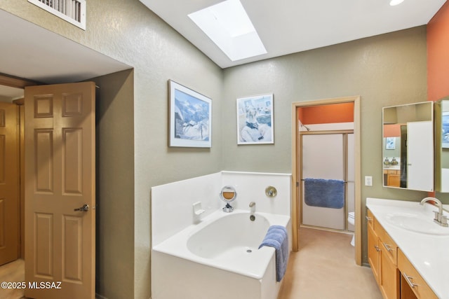 full bathroom with visible vents, a shower stall, a skylight, a bath, and vanity