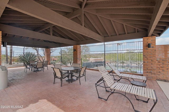 view of patio / terrace featuring a gazebo, outdoor dining space, and fence