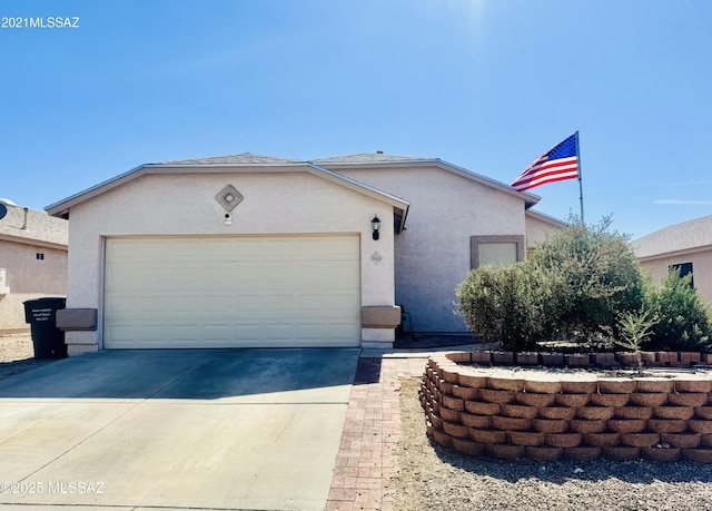 ranch-style house with an attached garage, concrete driveway, and stucco siding