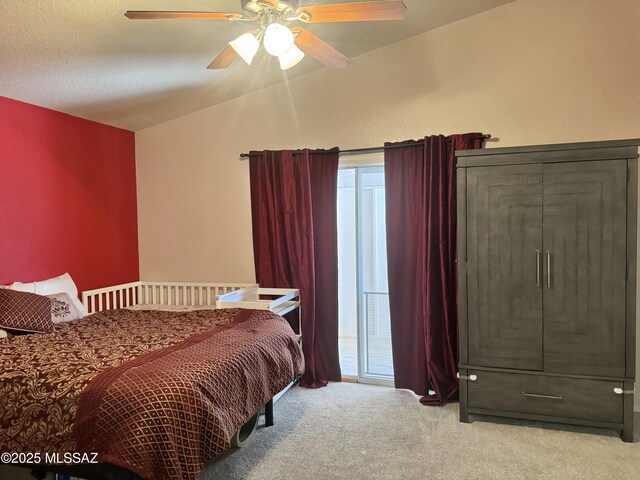 carpeted bedroom with a ceiling fan and vaulted ceiling