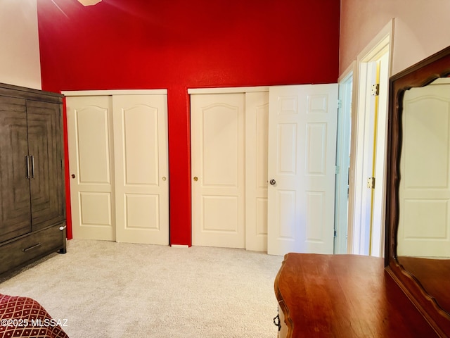 bedroom with carpet and multiple closets