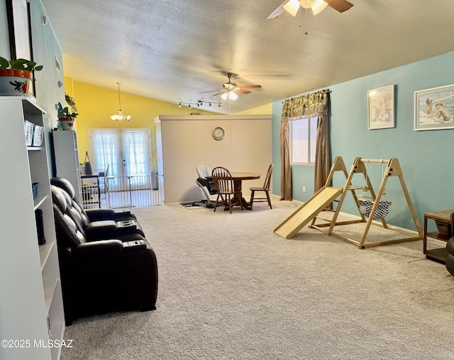 carpeted living room featuring a ceiling fan, lofted ceiling, rail lighting, a textured ceiling, and french doors