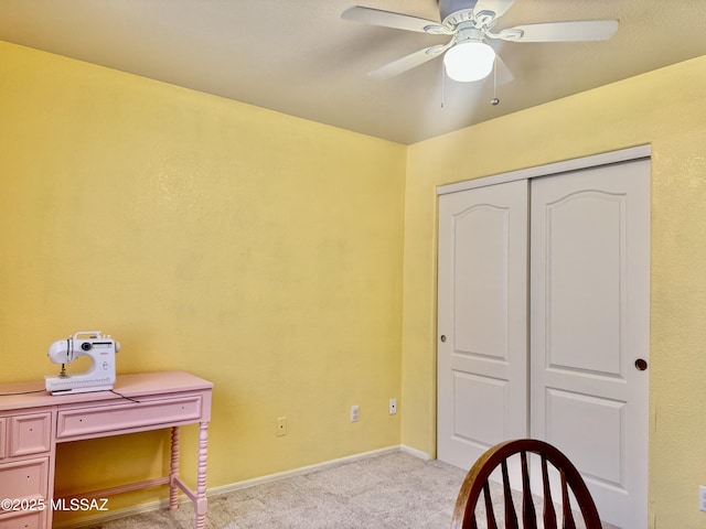 unfurnished office with carpet floors, baseboards, and a ceiling fan