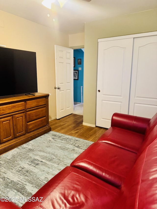 living area with wood finished floors and baseboards