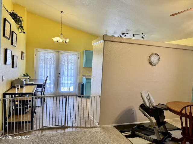 kitchen with carpet, french doors, vaulted ceiling, a chandelier, and baseboards