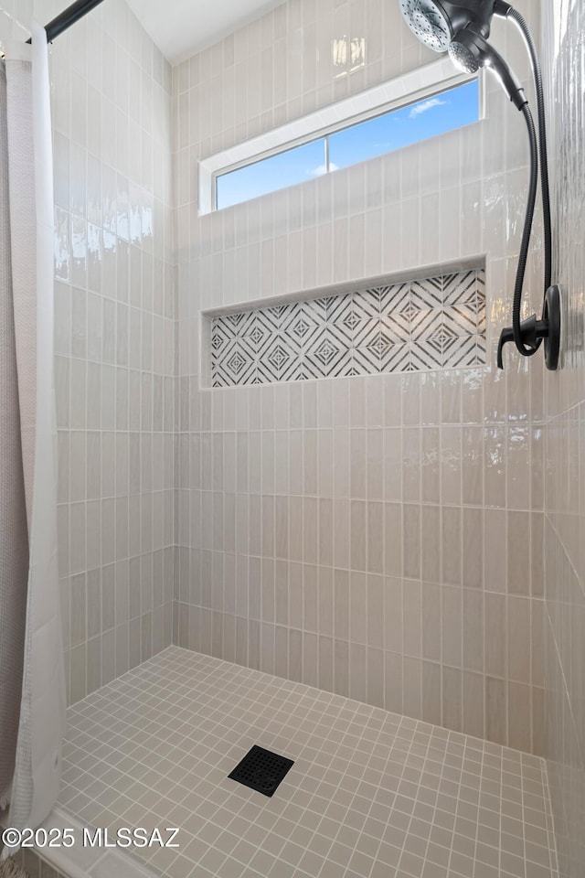 bathroom with a tile shower