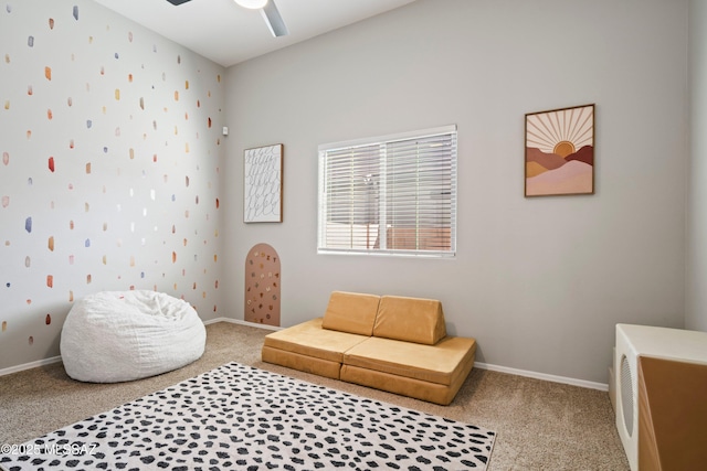 carpeted bedroom with ceiling fan and baseboards