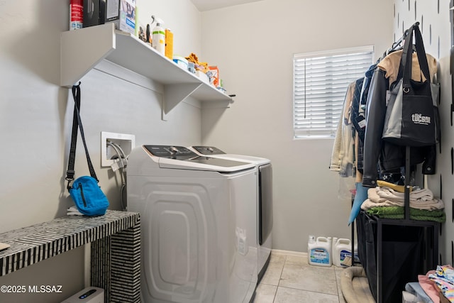 laundry area featuring light tile patterned floors, laundry area, and washing machine and clothes dryer