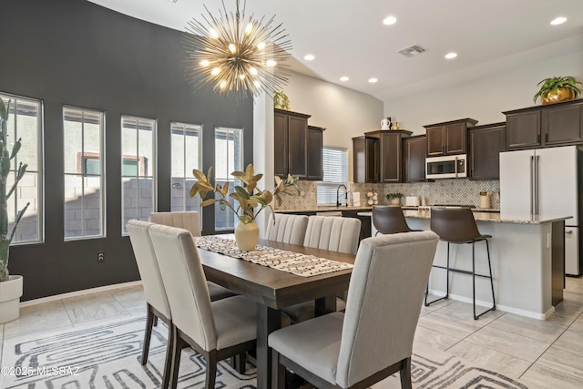 dining room featuring an inviting chandelier, a high ceiling, visible vents, and recessed lighting