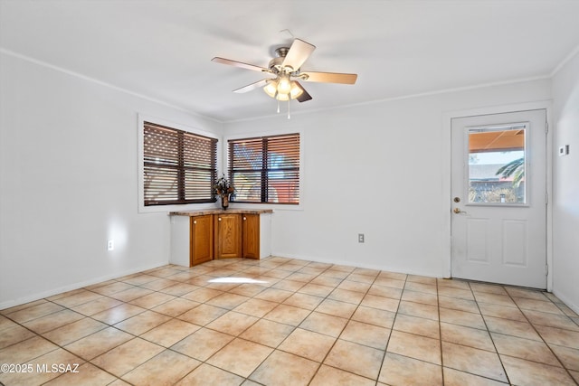 unfurnished room featuring a ceiling fan and crown molding