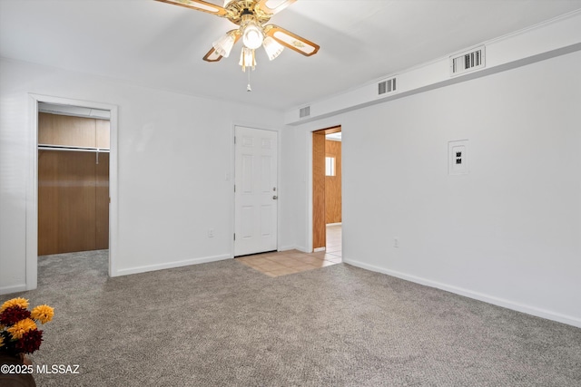 unfurnished bedroom with visible vents, carpet floors, and baseboards