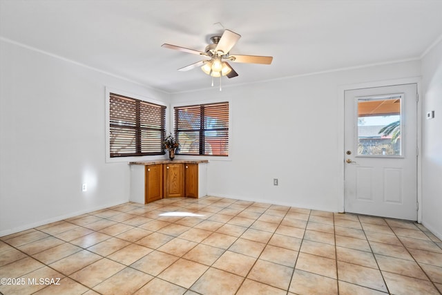 5822 E S Wilshire Dr, Tucson, AZ 85711 - unfurnished room with a ceiling fan, ornamental molding, and light tile patterned floors