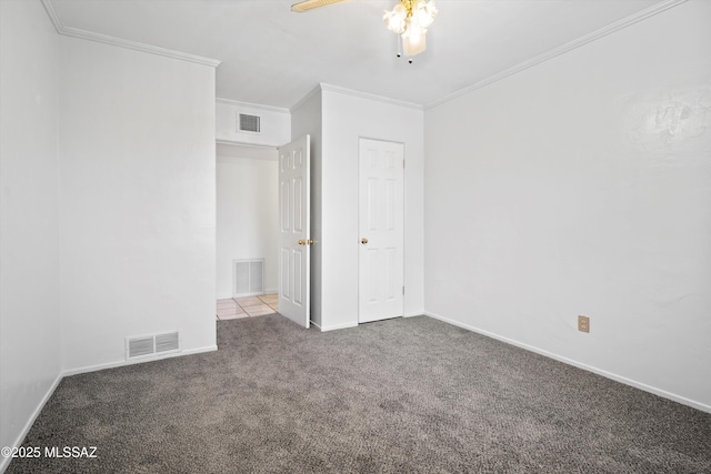 unfurnished bedroom with visible vents, ornamental molding, and carpet flooring