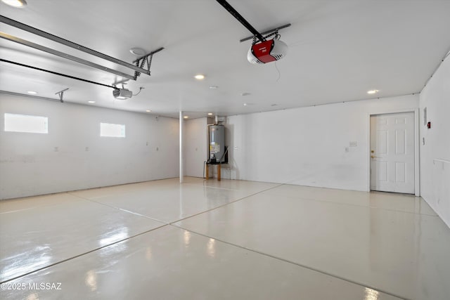 garage with gas water heater and a garage door opener